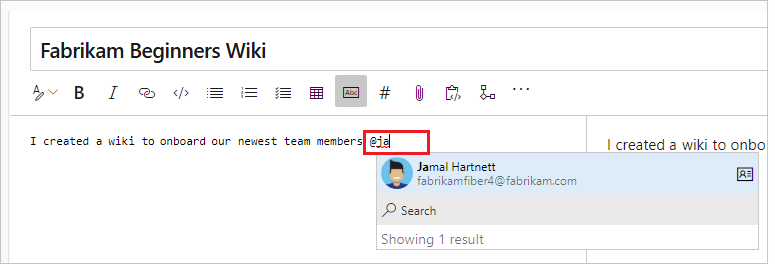 Screenshot that shows how to select a user in the Autosuggest dialog to add an @ mention in the wiki page.
