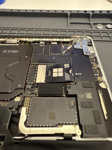 Screenshot that shows the speaker wire routing near the SSD receptacle to ensure it isn't caught when fastening the Removable Solid-State Drive.