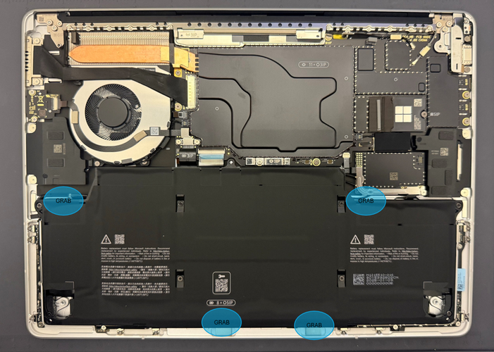 Screenshot that shows grabbing the battery at the four points and lifting it out of the device.
