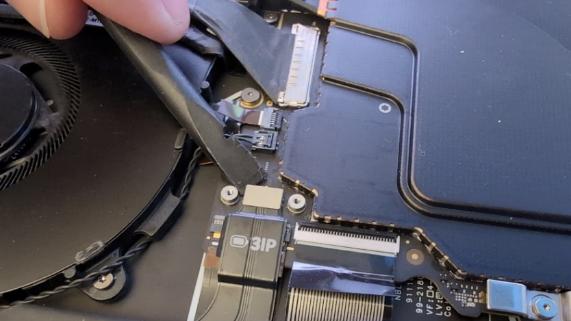 Screenshot that shows disconnecting the battery FPC connector from the motherboard using a nylon spudger.